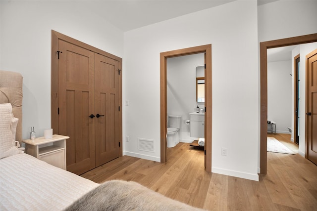 124 W 2nd St Unit B, Whitefish, MT 59937 - bedroom with light wood-style flooring, baseboards, a closet, and connected bathroom