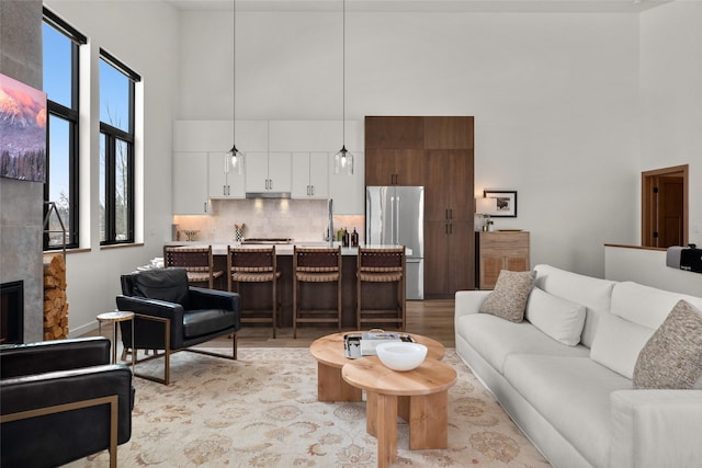 124 W 2nd St Unit B, Whitefish, MT 59937 - living area with a high ceiling, light wood-type flooring, and a fireplace