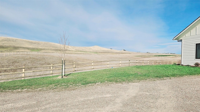 view of yard with a rural view and fence