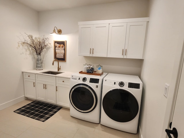 laundry room with light tile patterned floors, a sink, baseboards, washer and dryer, and cabinet space