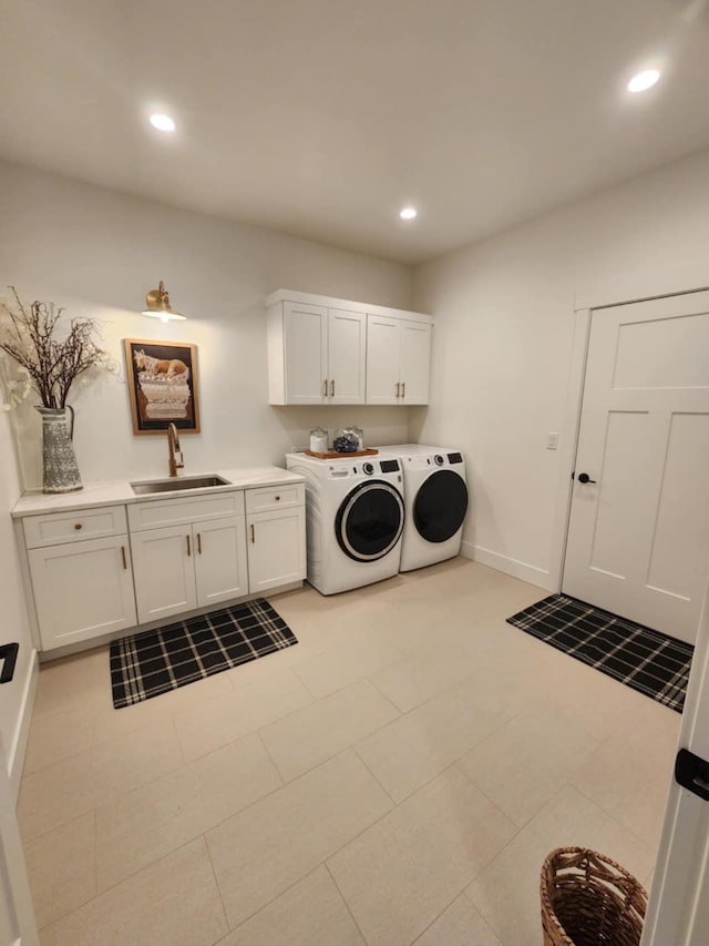 laundry room featuring cabinet space, baseboards, washing machine and dryer, a sink, and recessed lighting