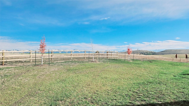 view of yard featuring a rural view and fence