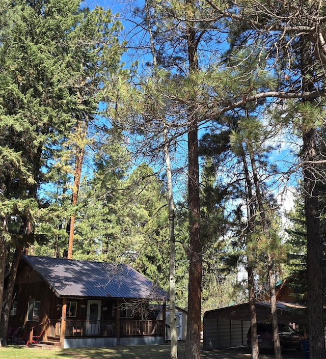 920 N 3rd St, Lincoln, MT 59639 - view of side of home featuring a porch and metal roof