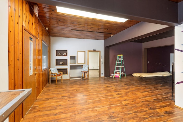 interior space with wooden walls, hardwood / wood-style floors, and wooden ceiling