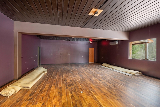 unfurnished room featuring hardwood / wood-style flooring and a wall unit AC