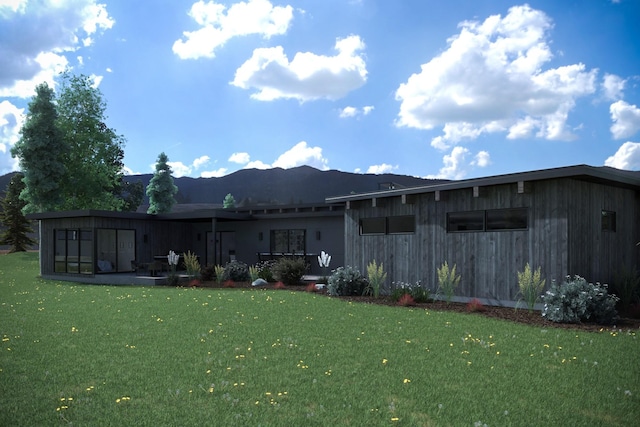 10580 Royal Coachman Dr, Missoula, MT 59808 - rear view of house featuring a lawn and a mountain view