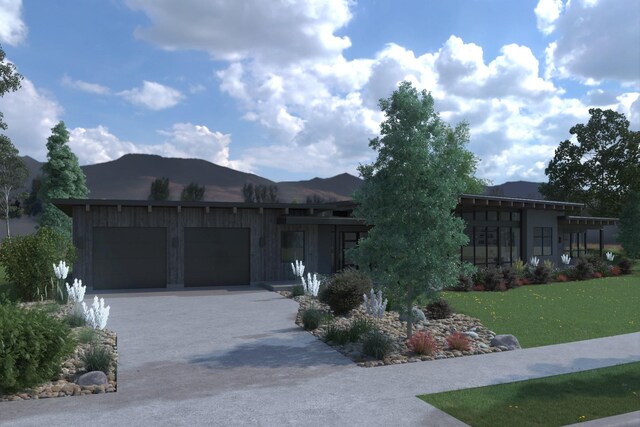 10580 Royal Coachman Dr, Missoula, MT 59808 - view of front of house with a mountain view, a garage, and a front lawn
