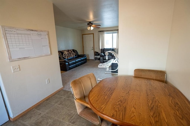 dining space with carpet flooring and ceiling fan