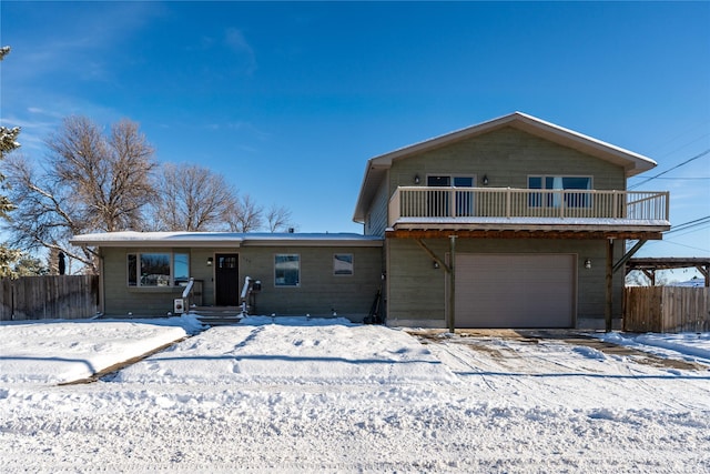 view of front of property with a balcony and a garage