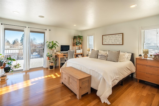 bedroom featuring access to exterior and light hardwood / wood-style flooring