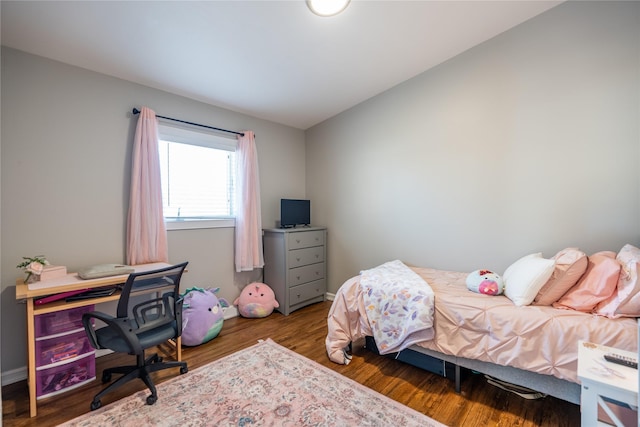 bedroom with dark wood-type flooring