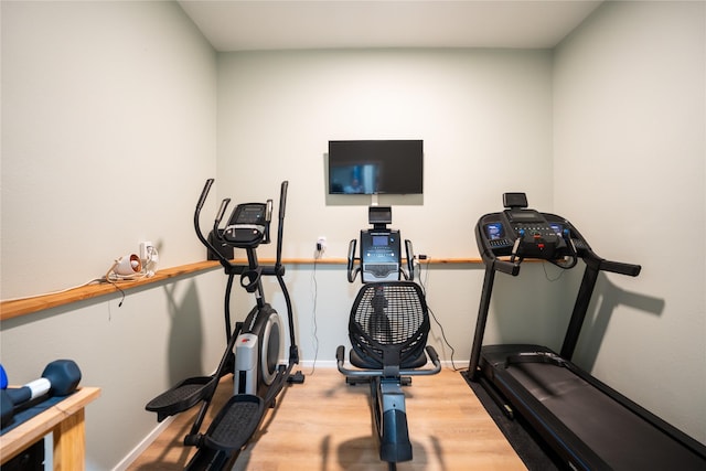 workout room with light hardwood / wood-style floors