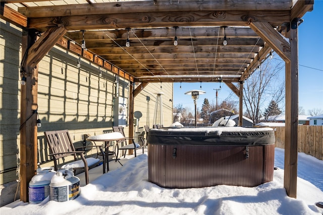 snow covered patio with a hot tub