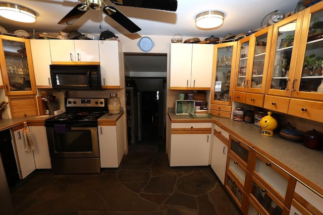 kitchen with a ceiling fan, black microwave, white cabinets, electric stove, and glass insert cabinets