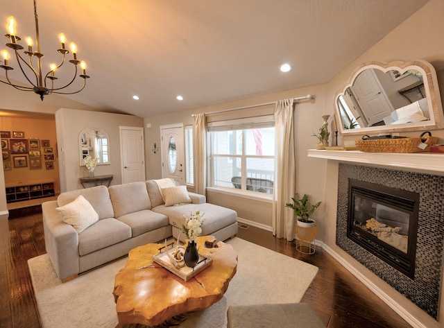 living area with recessed lighting, dark wood-style flooring, a fireplace, baseboards, and vaulted ceiling