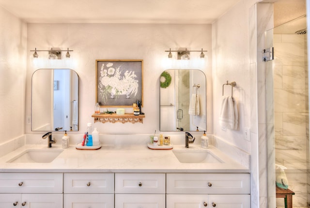 full bathroom with a stall shower, a sink, and double vanity