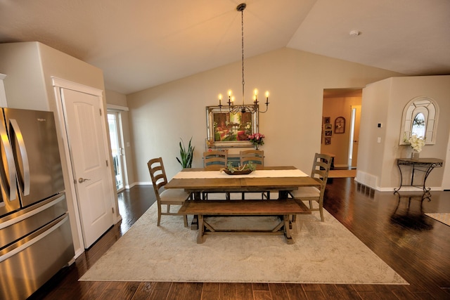 dining area with vaulted ceiling, dark wood-type flooring, an inviting chandelier, and baseboards