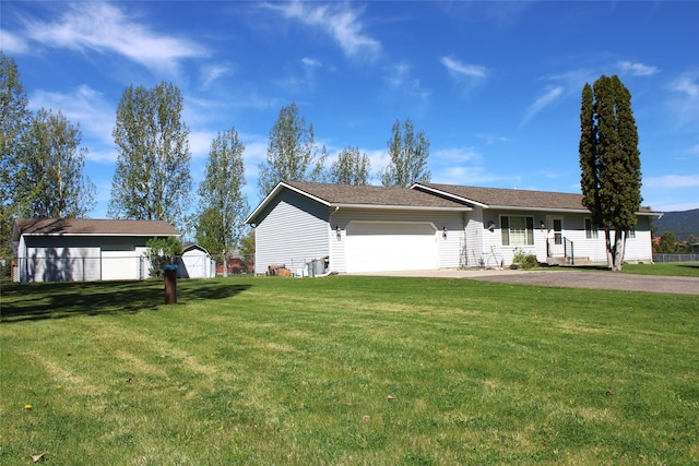 15 Sully Rd, Plains, MT 59859 - view of front of house featuring a garage, a front lawn, a storage shed, and driveway