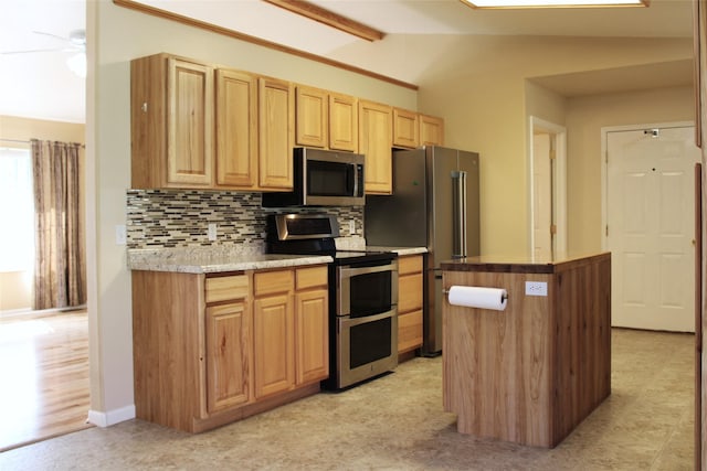 15 Sully Rd, Plains, MT 59859 - kitchen with appliances with stainless steel finishes, light brown cabinetry, backsplash, a center island, and light countertops