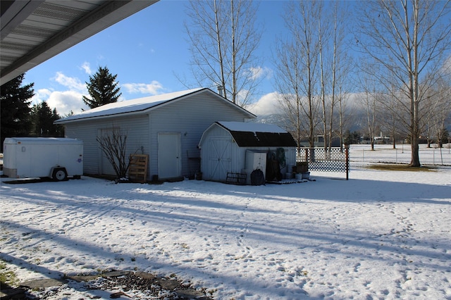 view of snow covered exterior featuring a storage unit