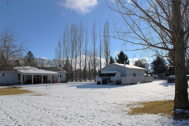 view of snow covered back of property