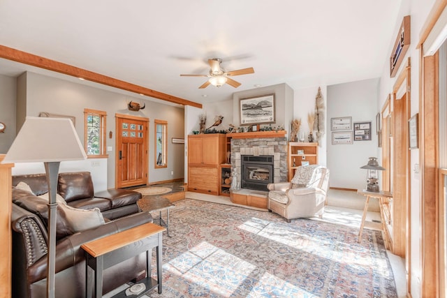 living room featuring a wood stove and ceiling fan