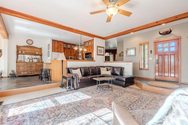 living room featuring ceiling fan with notable chandelier