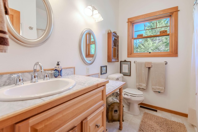 bathroom with vanity and toilet