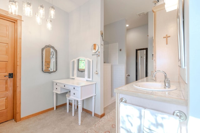 bathroom featuring a shower and vanity