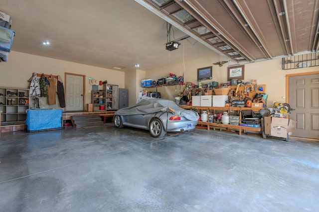 garage with a workshop area and a garage door opener