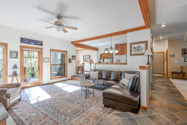 living room with beamed ceiling and ceiling fan with notable chandelier