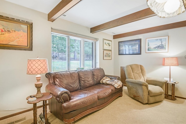 carpeted living room featuring beamed ceiling and a notable chandelier