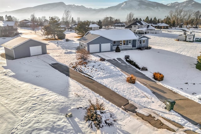 snowy aerial view with a mountain view