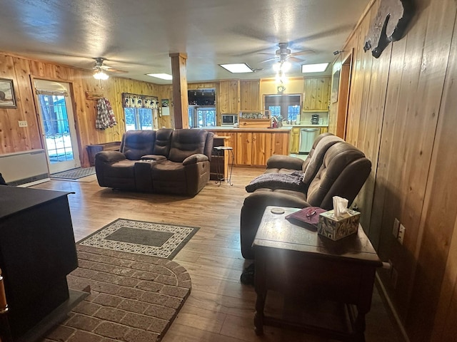 27 Birch Ln, Trout Creek, MT 59874 - living area with ceiling fan, wood walls, and light wood-style floors