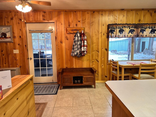 27 Birch Ln, Trout Creek, MT 59874 - dining room featuring a ceiling fan, wooden walls, and light tile patterned flooring