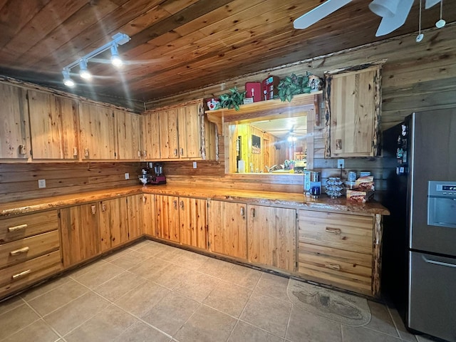 kitchen featuring stainless steel refrigerator, wooden walls, wood ceiling, and track lighting