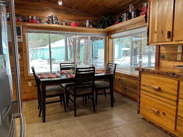 27 Birch Ln, Trout Creek, MT 59874 - dining area with vaulted ceiling, wooden walls, and a wealth of natural light