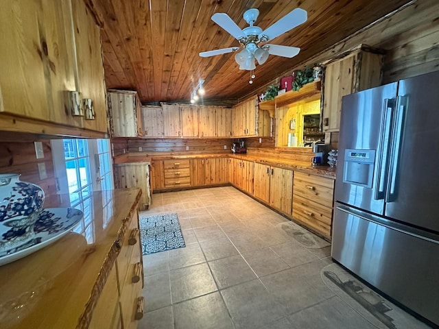 27 Birch Ln, Trout Creek, MT 59874 - kitchen with stainless steel refrigerator with ice dispenser, wood ceiling, wooden walls, ceiling fan, and light countertops