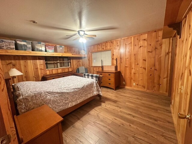 27 Birch Ln, Trout Creek, MT 59874 - bedroom with ceiling fan, wooden walls, and hardwood / wood-style floors