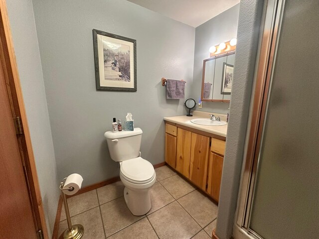 27 Birch Ln, Trout Creek, MT 59874 - full bathroom featuring toilet, vanity, tile patterned flooring, a shower with shower door, and baseboards