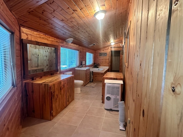 bathroom with wood ceiling, a washtub, vaulted ceiling, wooden walls, and toilet