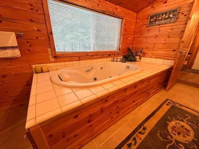 bathroom featuring wooden ceiling, wooden walls, vaulted ceiling, tile patterned flooring, and a tub to relax in