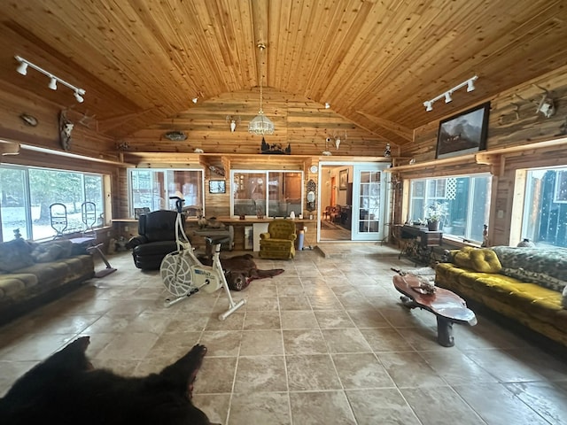 tiled living room featuring wooden walls, high vaulted ceiling, wood ceiling, and track lighting