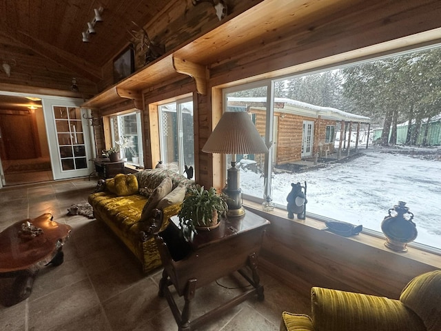 sunroom featuring lofted ceiling and wood ceiling