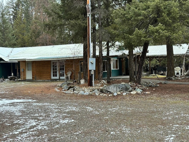 27 Birch Ln, Trout Creek, MT 59874 - view of front of property featuring metal roof, dirt driveway, and french doors