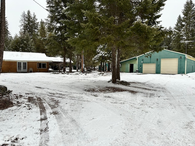 view of front of home with a garage and an outdoor structure