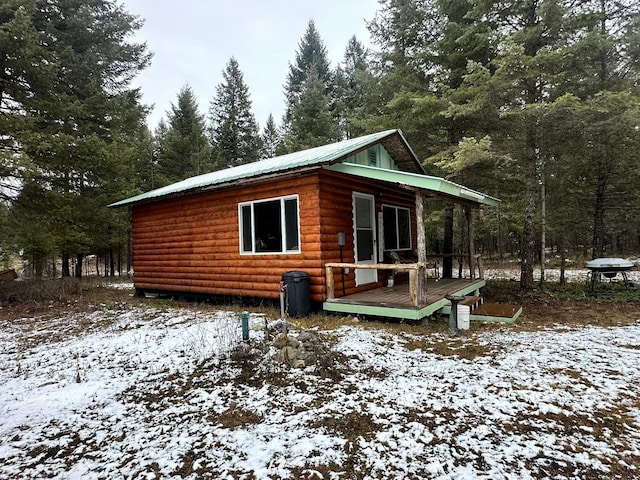 snow covered house with a deck