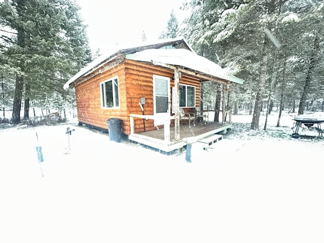 view of snow covered back of property