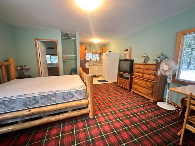 27 Birch Ln, Trout Creek, MT 59874 - carpeted bedroom with freestanding refrigerator