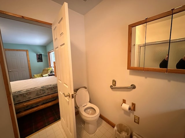 27 Birch Ln, Trout Creek, MT 59874 - bathroom featuring toilet, baseboards, and tile patterned floors